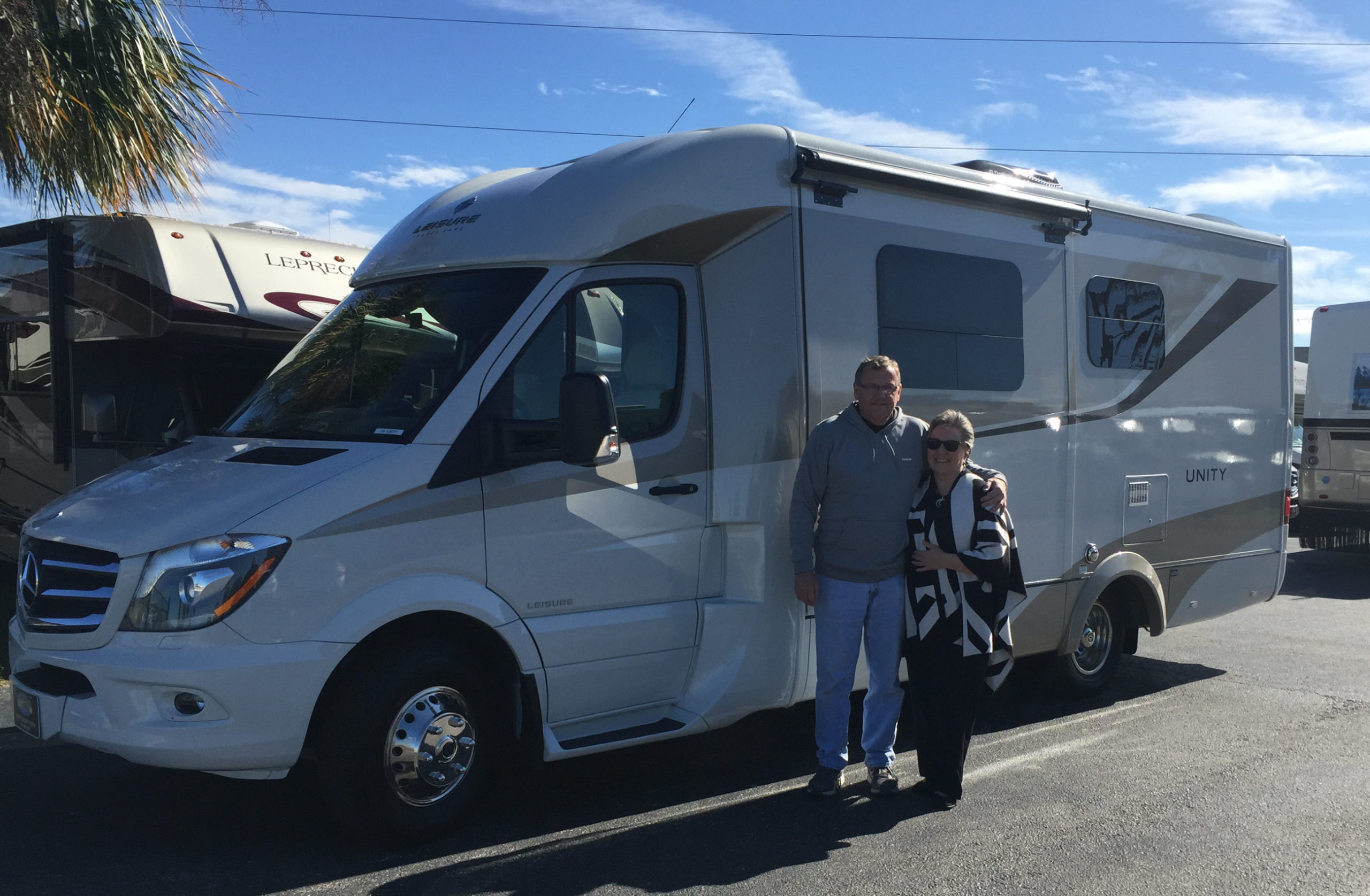 Couple standing in front of RV