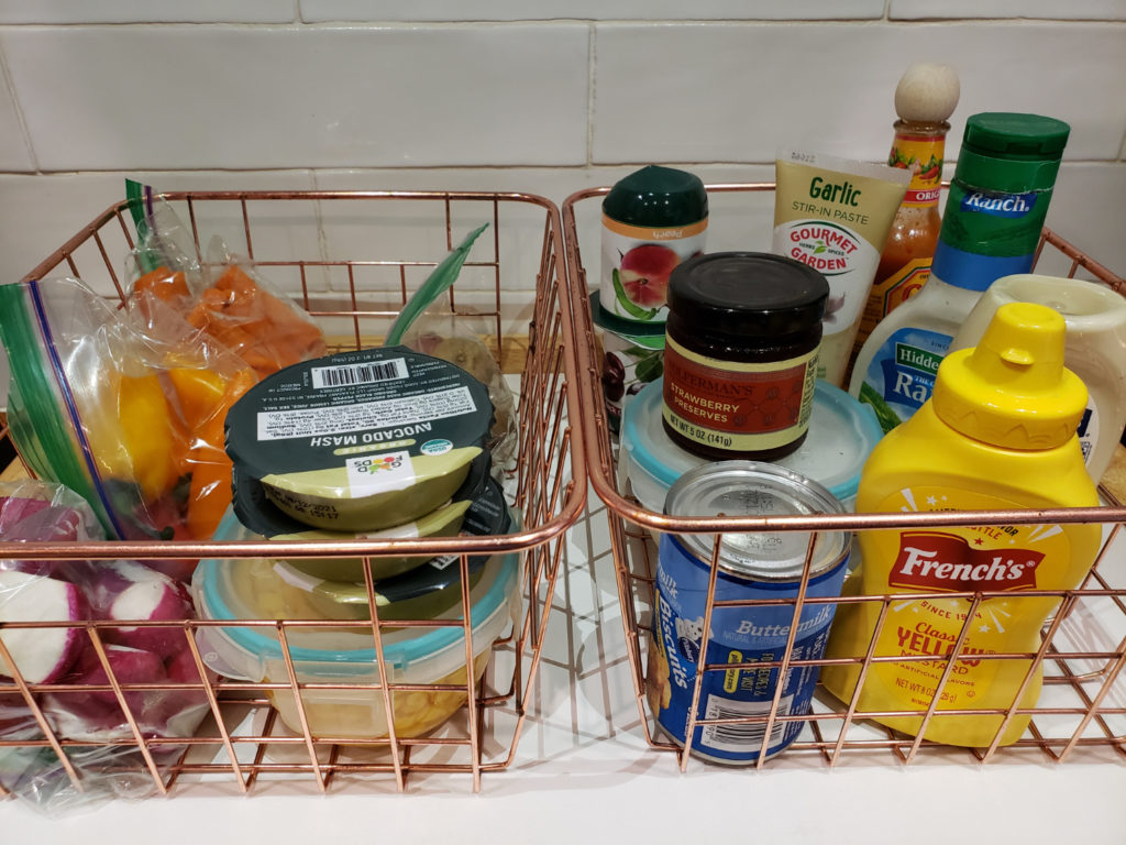 wire baskets of food in the fridge
