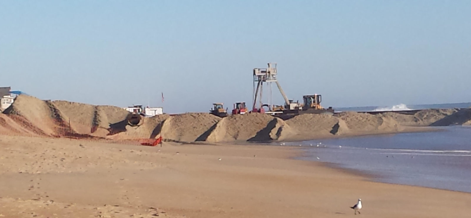 Bulldozers shaping the sand dunes