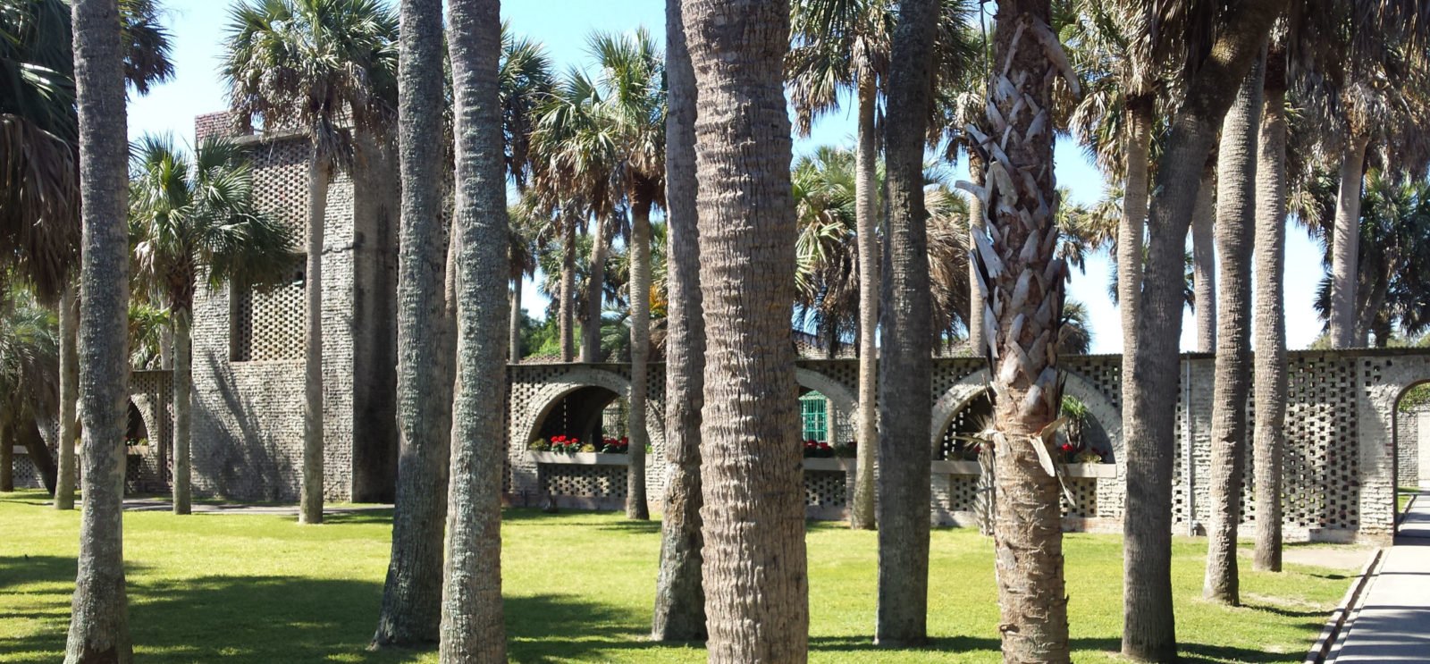 Palm trees and brick building courtyard