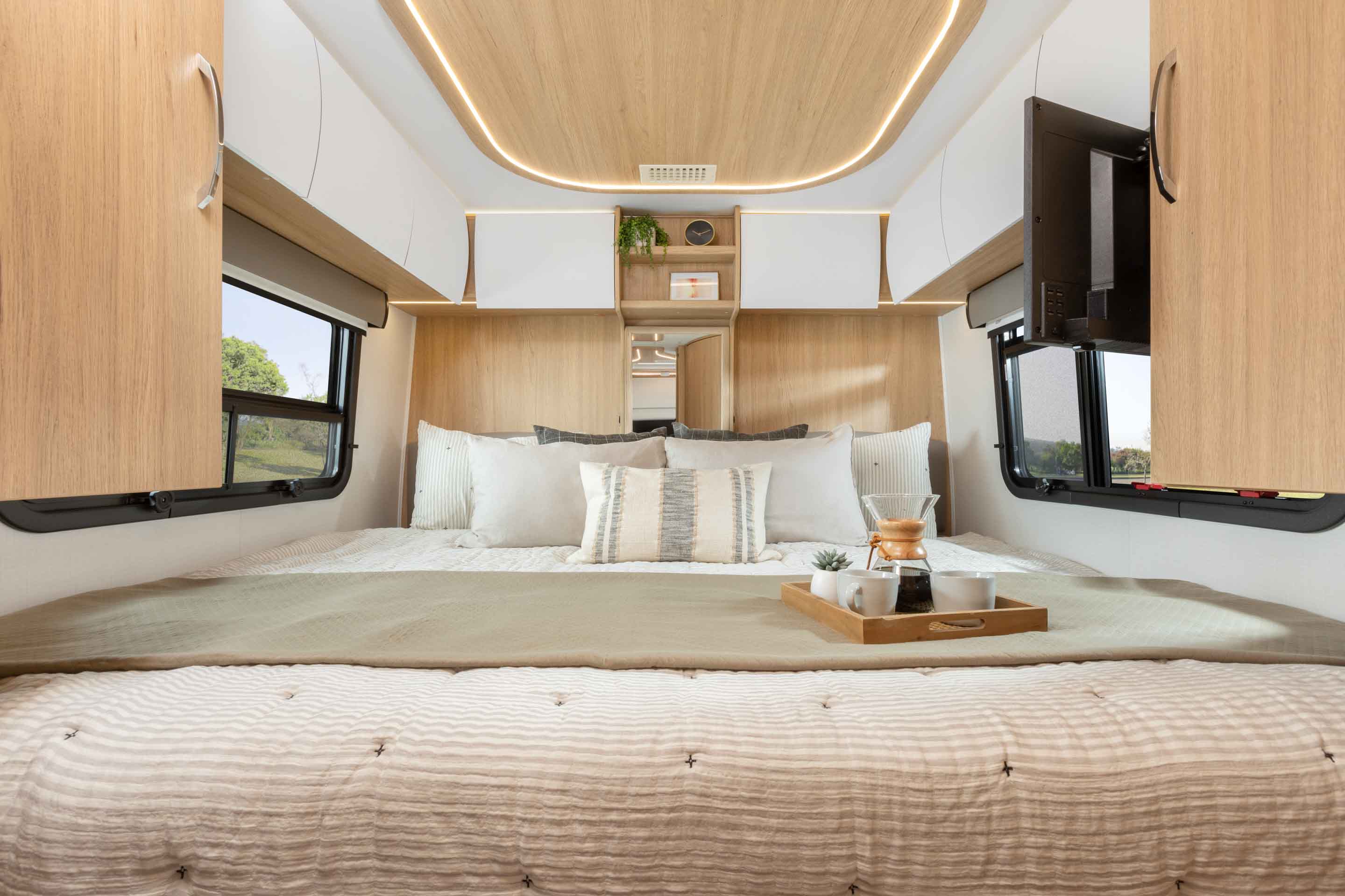 2023 Unity Twin Bed shown with Rift Oak cabinetry, Bianco White cabinetry upgrade, Antarctica countertops, and Clay upholstery.