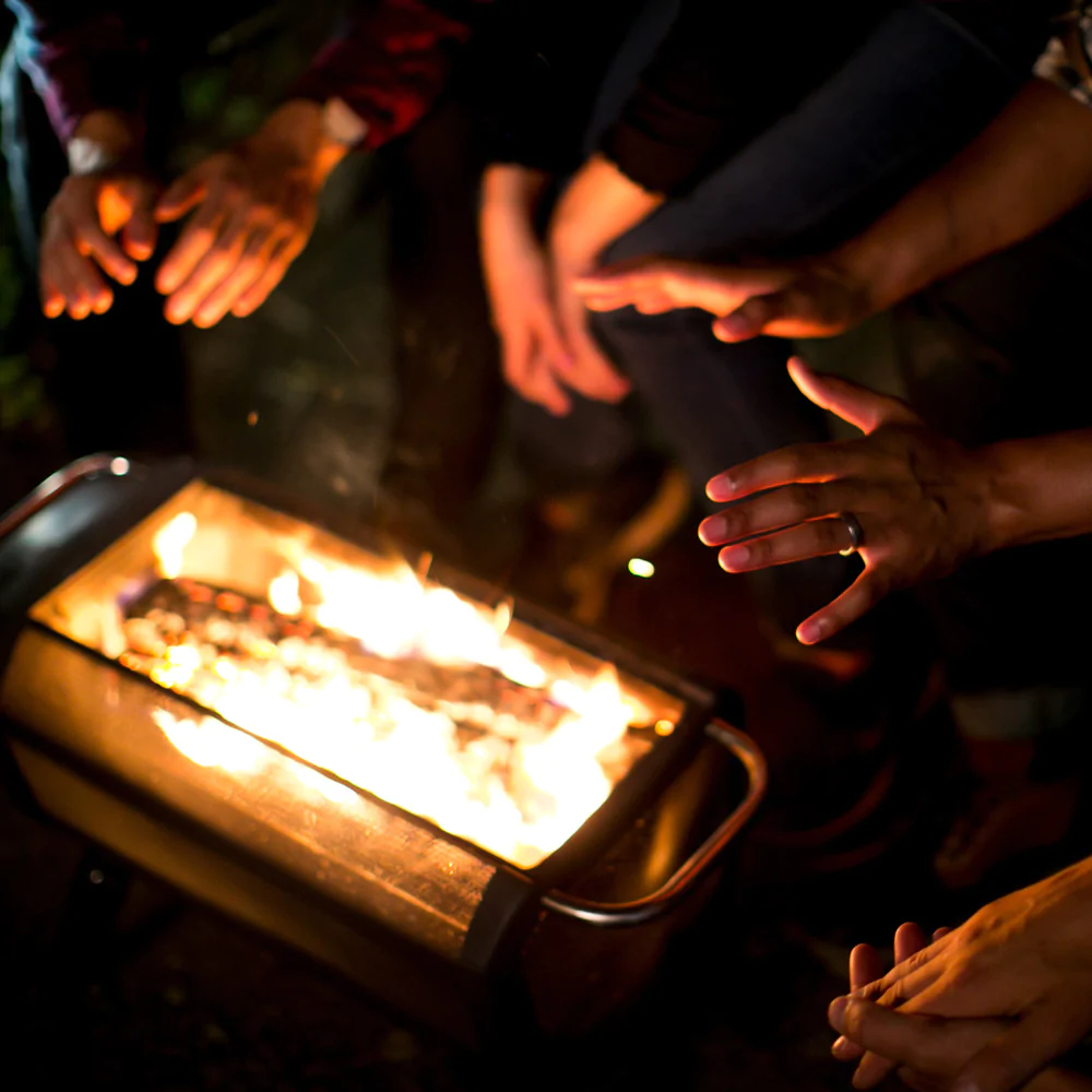 People warming hands over a BioLite fire pit