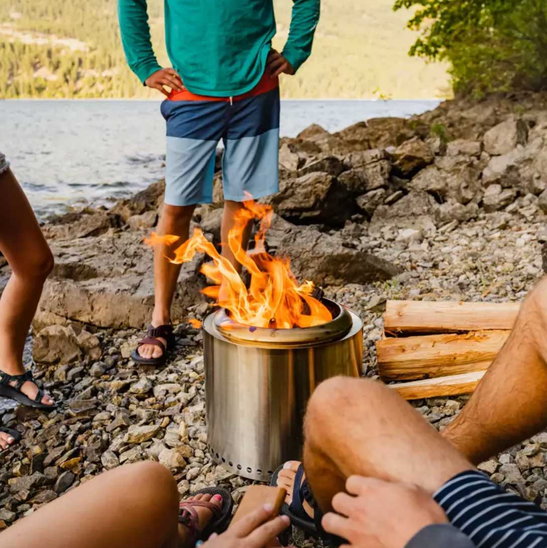 People gathered around a Solo Stove