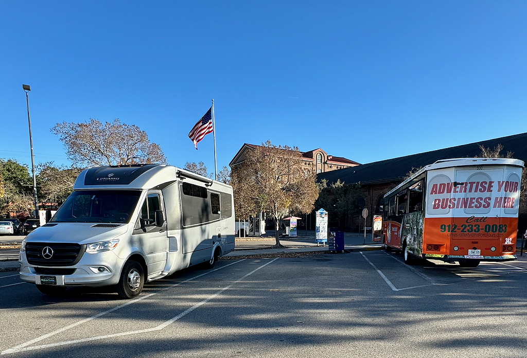 An LTV Unity MB next to a Historic Tours Trolley at the visitors center parking lot in Savannah, Georgia