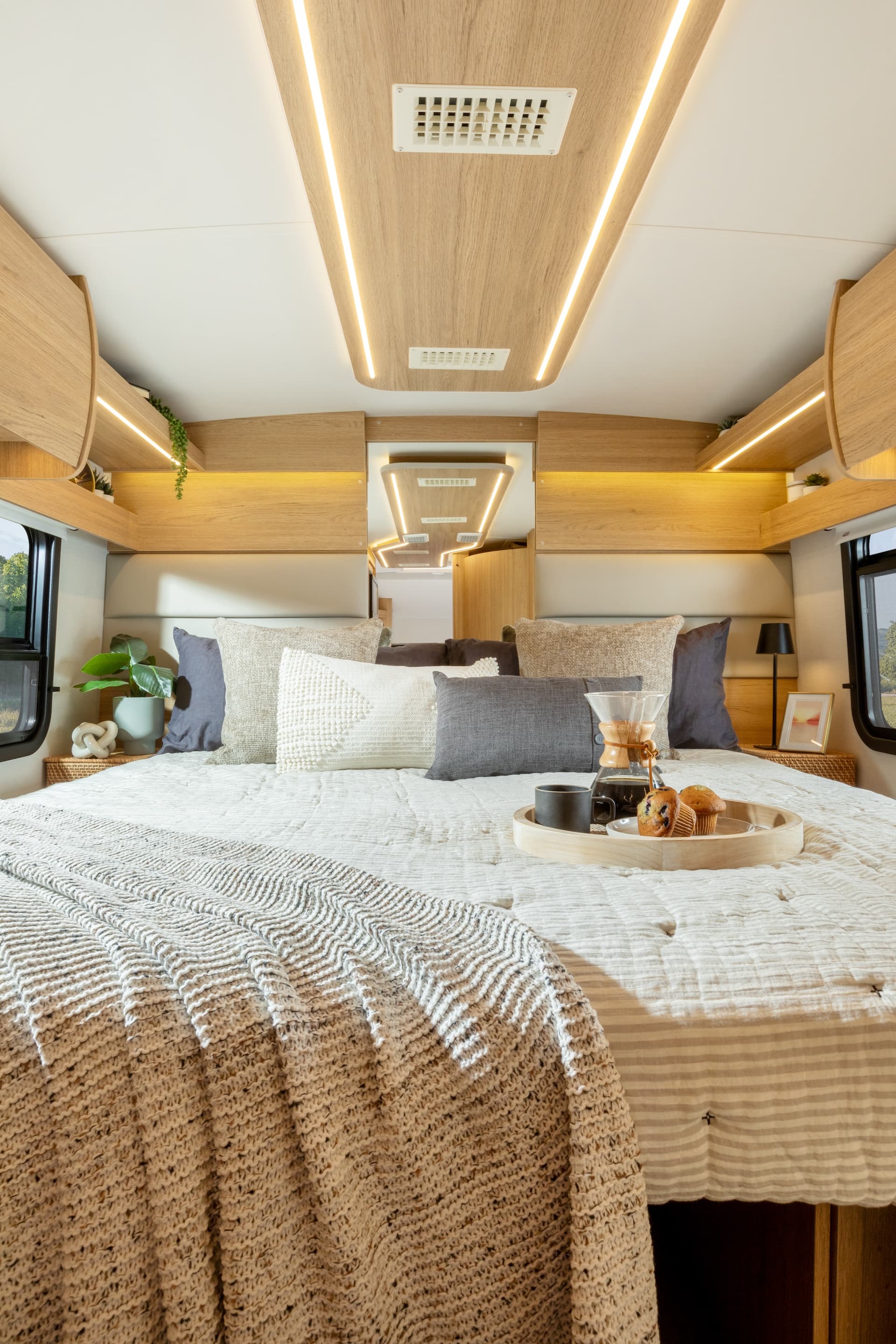 2025 Wonder Rear Twin Bed shown with Rift Oak cabinetry, Antarctica countertops, and Sand upholstery.