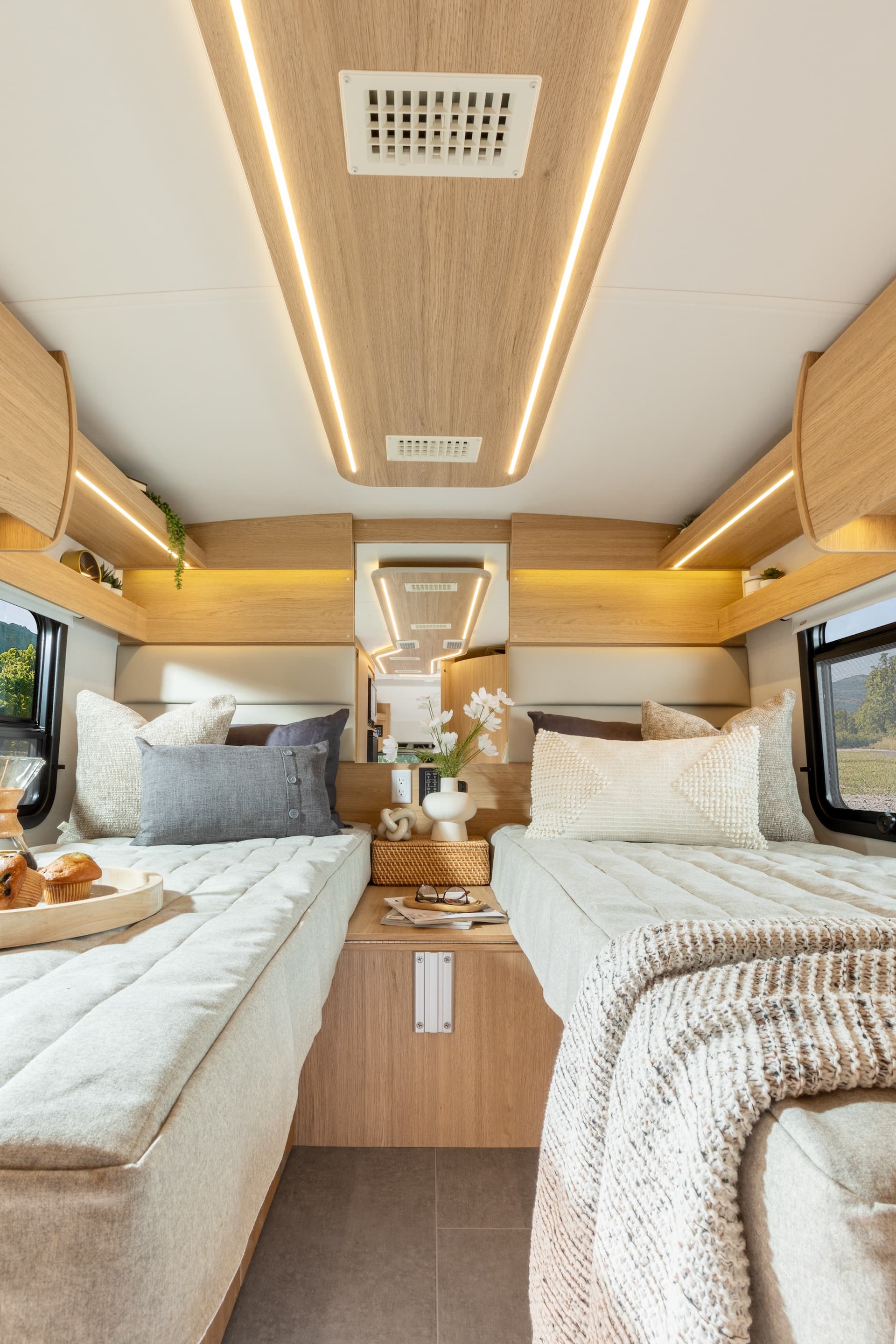 2025 Wonder Rear Twin Bed shown with Rift Oak cabinetry, Antarctica countertops, and Sand upholstery.