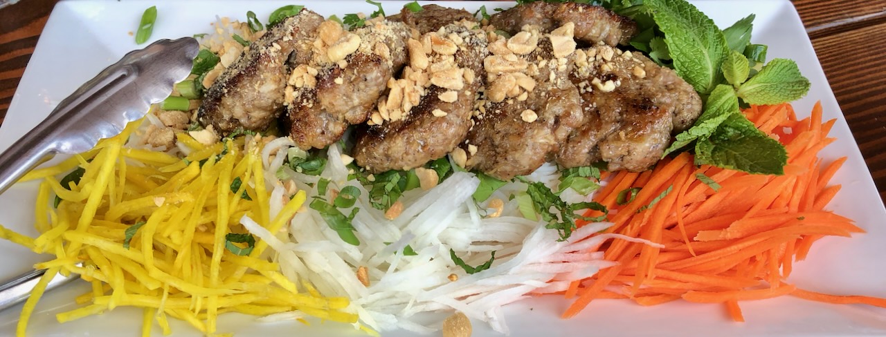 Burmese salad: pork patties, crispy vegetables, rice noodles, mint and peanuts served with Nuoc cham sauce sauce.