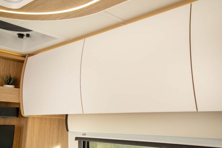 Unity Twin Bed shown with Rift Oak cabinetry, Crystal White cabinetry, Concrete countertops, and Dove upholstery.
